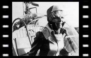 Image of Astrid Ferrier (Mary Peach) near the helicopter