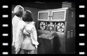 Image of Isobel (Sally Faulkner), and Zoe at the IE computer