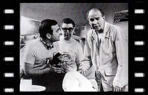 Image of Benoit (Andre Maranne), Bob (Edward Phillips), (Hobson (Patrick Barr) with a plague victim