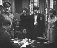 Image of Sergeant-Major Burns (Esmond Webb), Captain Ransom (Hubert Rees)at table, Jamie, Doctor, & Zoe