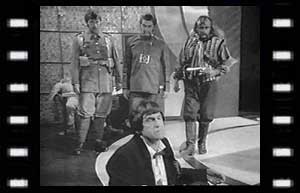Image of Petrov (Stephen Hubay), War Chief (Edward Brayshaw), Arturo Villar (Michael Napier-Brown), watch the Doctor preparing to contact the Time Lords