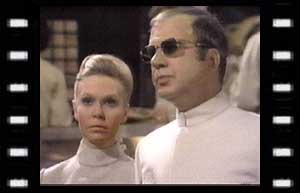 Image of Petra Williams (Sheila Dunn) & Professor Stahlman (Olaf Pooley) in fascist world