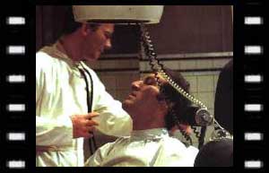 Image of Professor Kettering (Simon Lack) treating Barnham (Neil McCarthy)