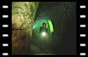 Image of Stubbs (Christopher Coll) in caves