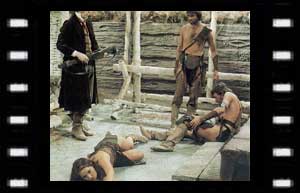 Image of the Doctor with a paralyized Leela, Tomas (Brendan Price) and an injured Calib (Leslie Schofield)
