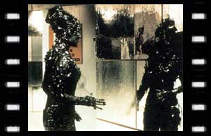 Image of Elrad (Judith Paris) looking at a reflective surface