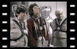 Image of Lester (William Marlowe), Doctor, and Stevenson (Ronald Leigh-Hunt) with bomb packs