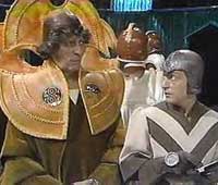 Image of the Doctor in Prydonian robes with Commentator Runcible (Hugh Walters)
