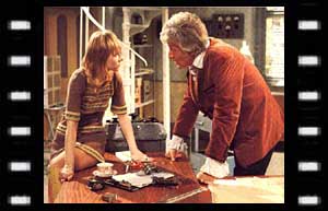 Image of Jo siting on desk, & The Doctor